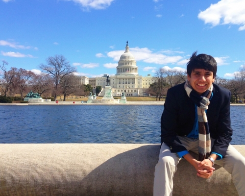 A student sitting in front of the national Capitol
