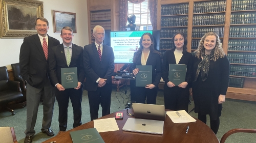 The student research team with the Justices after their final presentation.