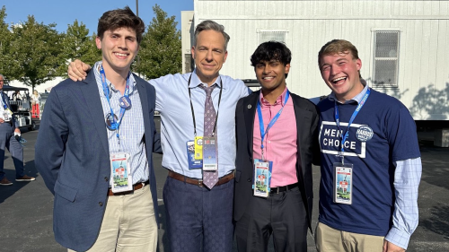  a photo of Jake Tapper with three students outside the DNC.