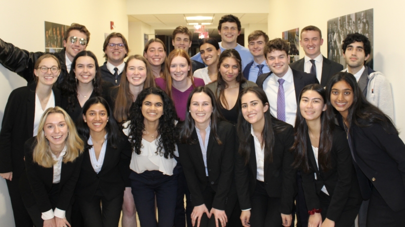 The mock trial team poses for a group photo in a hallway.
