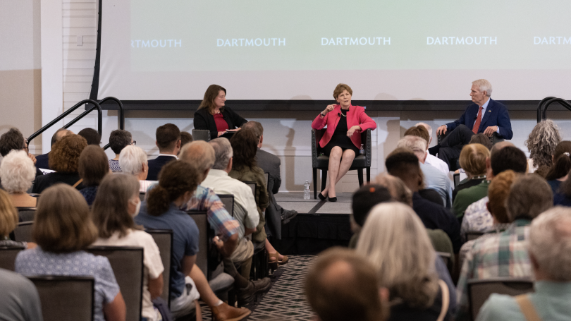 Senators Rob Portman '78 and Jeanne Shaheen on a stage with a crowd in the foreground