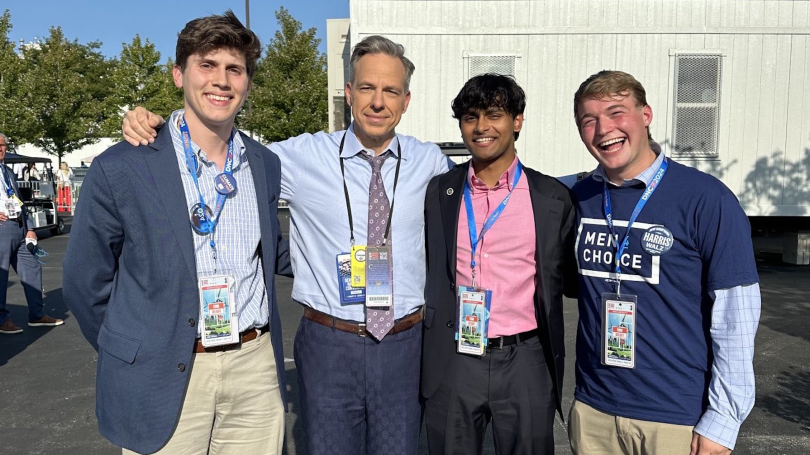  a photo of Jake Tapper with three students outside the DNC.