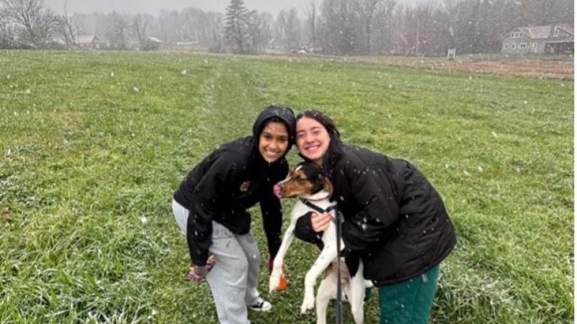 Students with a dog in a field