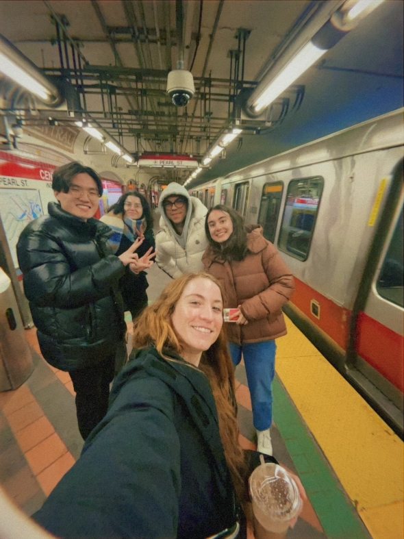 A group of students on a Boston subway platform.