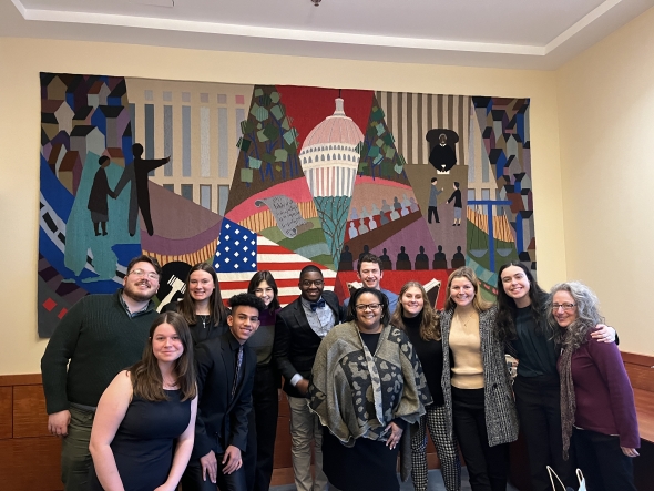 The students pose in front of a mural with Judge Cobb.