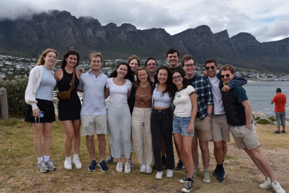 A group photo in front of the mountains and the ocean.