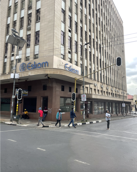 Photo of building with sign for Eskom. The traffic lights are not working.