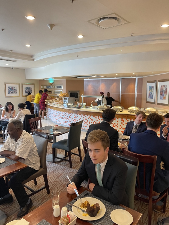 The students eat breakfast at the hotel.