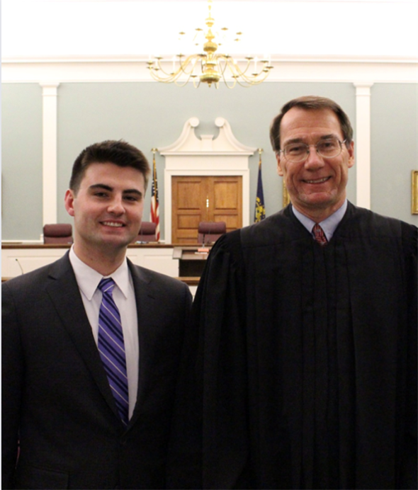Ethan Fairbanks standing next to the Justice