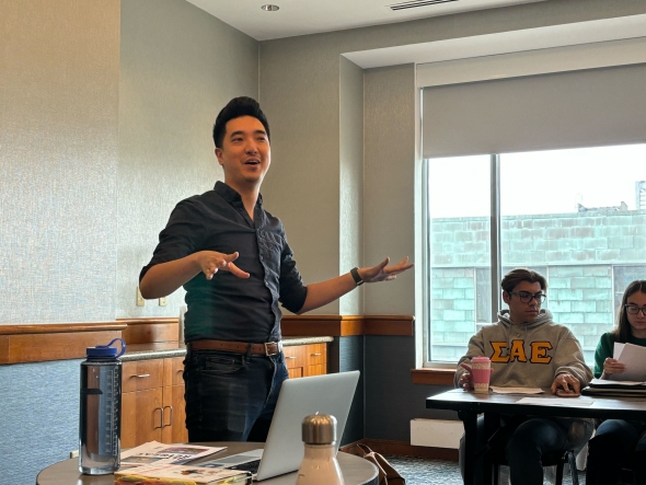Dan Feng lectures in front of a group of students.