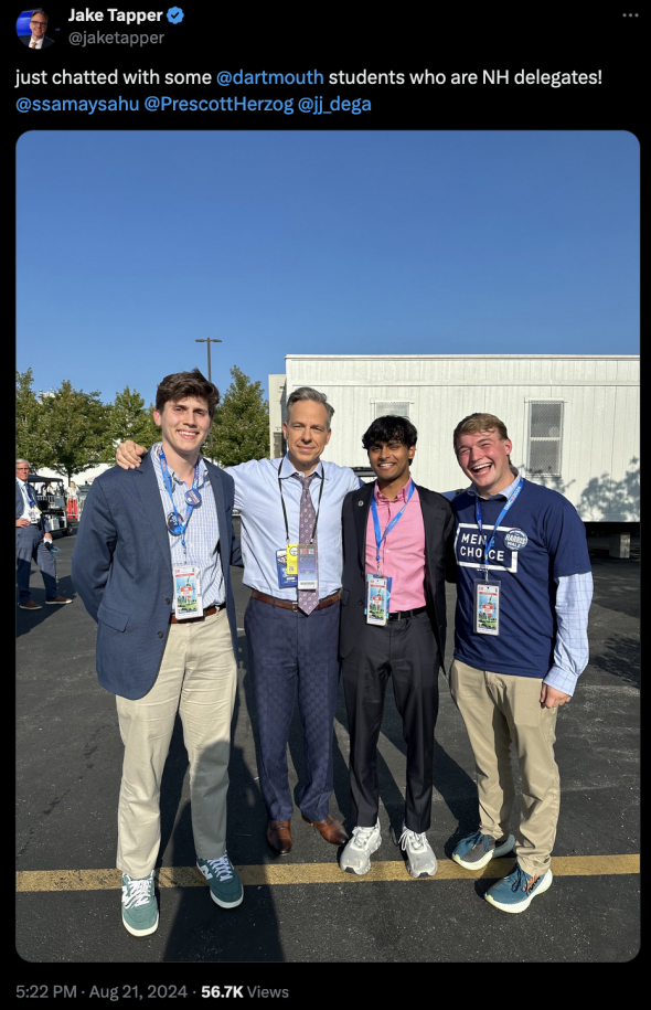 A screenshot of a tweet from Jake Tapper with a photo of Tapper with three students.