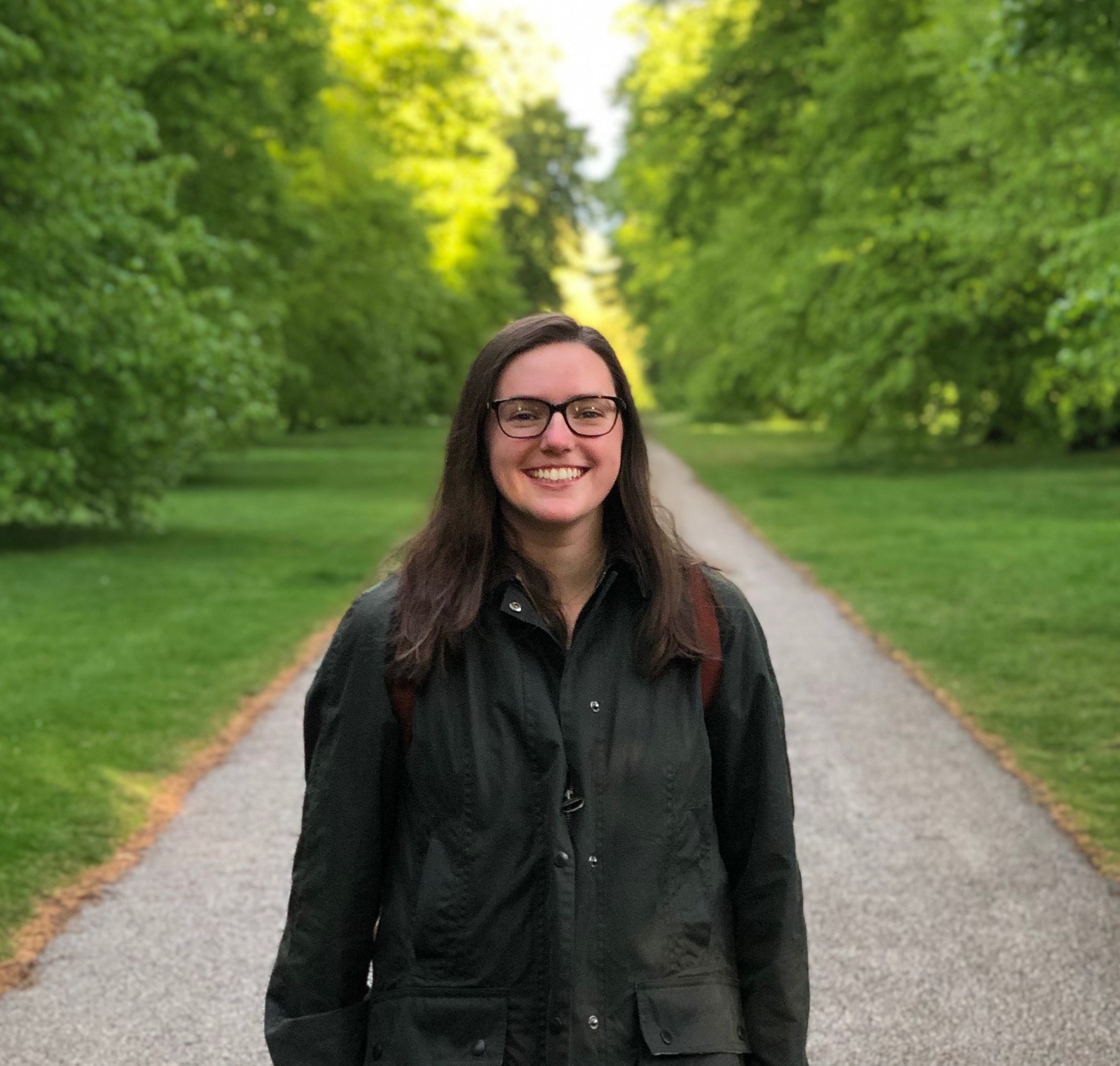 Sunny Drescher outside on a path with green trees