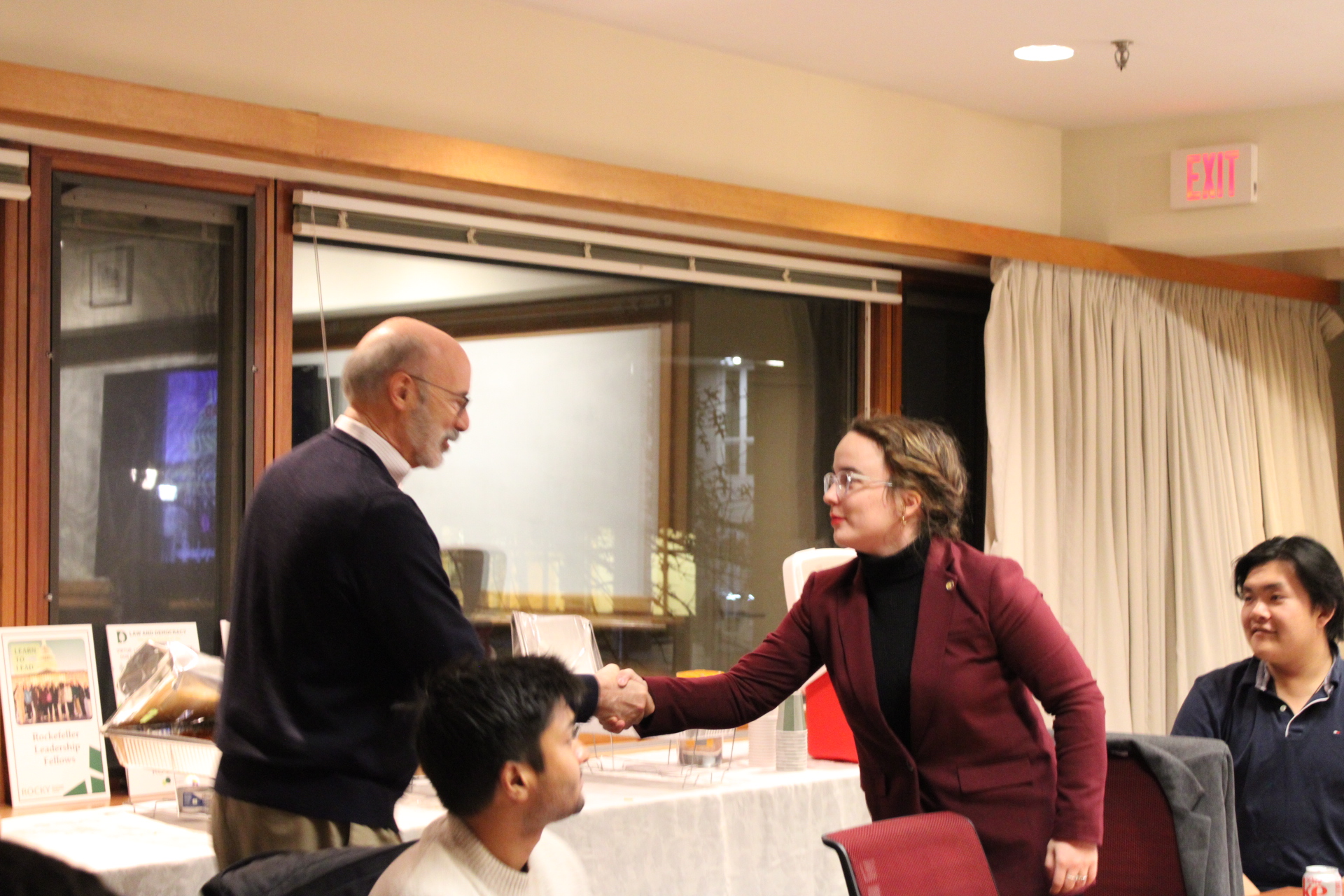 A student shakes hands with Former Gov. Tom Wolf.
