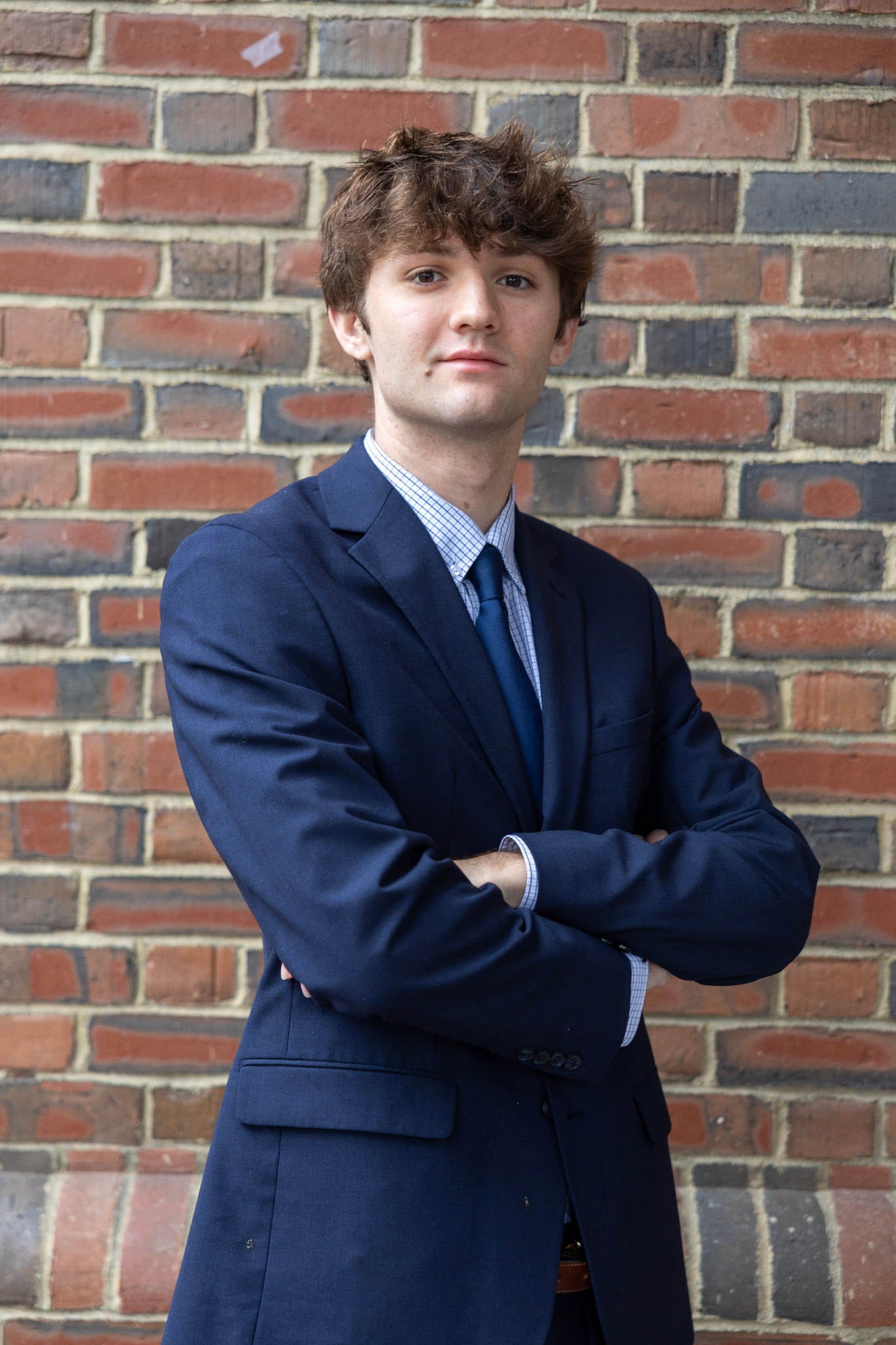 Ian standing against a brick wall.